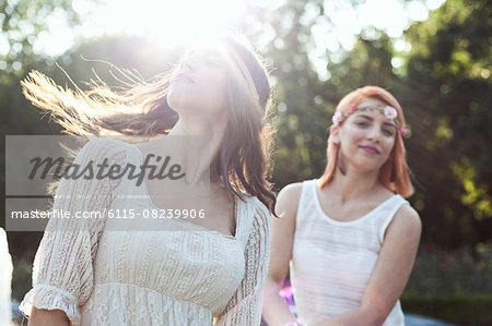 Young woman in hippie style fashion flicking her hair