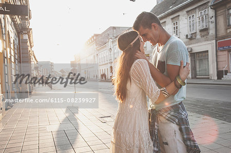 Young couple in hippie style fashion embracing