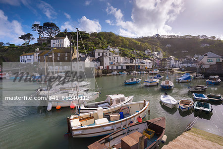 Fishing boats moored in picturesque Polperro harbour on a sunny spring evening, Cornwall, England, United Kingdom, Europe
