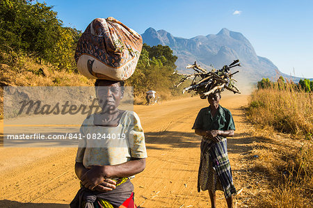 Local women carrying their goods on their heads in front of Mount Mulanje, Malawi, Africa