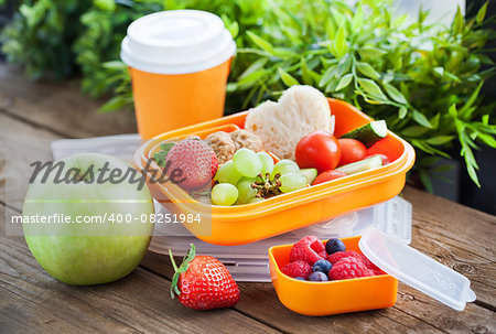 Lunch box for kids with sandwich, cookies, fresh veggies and fruits