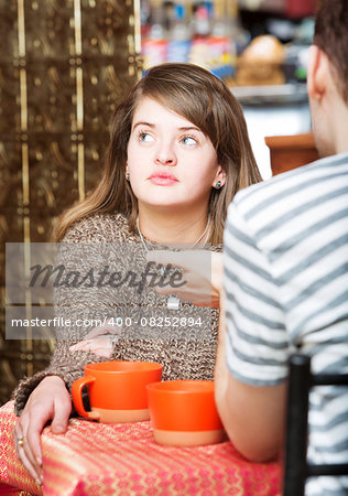 Young woman with friend in cafe daydreaming