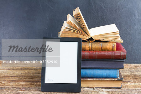 Pile of paper antique books with electronik book