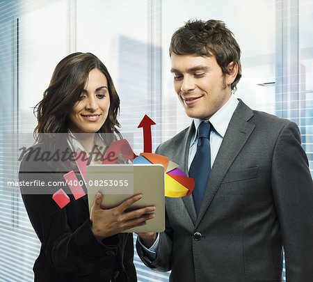 Business people analyze in a tablet graphics