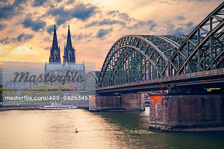 Image of Cologne with Cologne Cathedral and Hohenzollern bridge across the Rhine River.