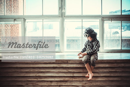 Little boy with plane indoors