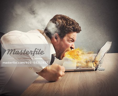Businessman spits fire and melts the computer