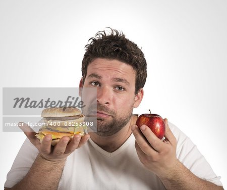 Man undecided between diet and junk food