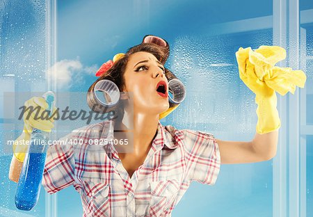 Pin-up housewife breathes on a clean glass