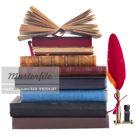 Tower of books with open book on top and red feather pen  isolated on white background