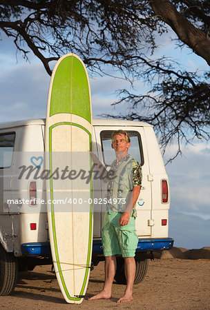 Single person with eyeglasses posing with surfboard