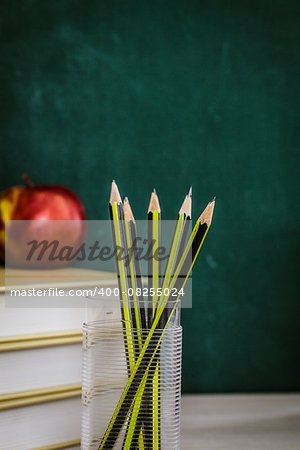 School objects for students. Chalkboard, pencils, crayons and apple