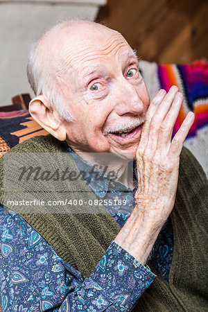 Elderly man in green vest sharing a secret