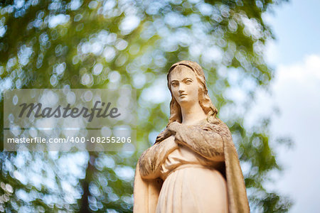 Statue of Virgin Mary at Rasu cemetery in Vilnius, Lithuania. Shot taken with a soft focus lens, shallow depth of field