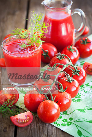 Fresh tomatoes and tomato juice on wooden table