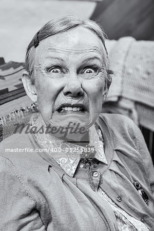Elderly woman making a scary face at the camera