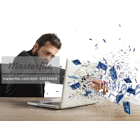 Angry businessman breaks the pc in office