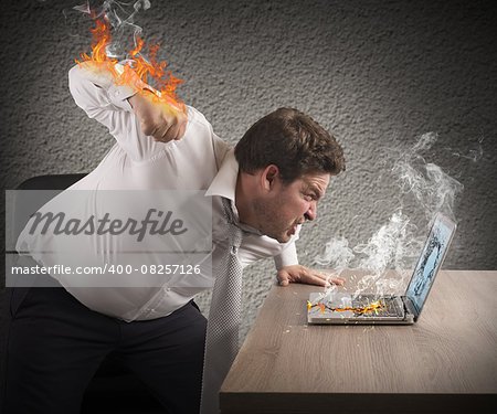 Angry man gives fiery fist to computer