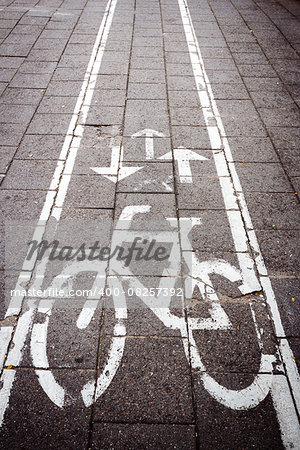 Bicycle road sign painted on the old concrete tile pavement