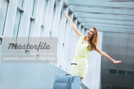 Young girl with a suitcase at the airport