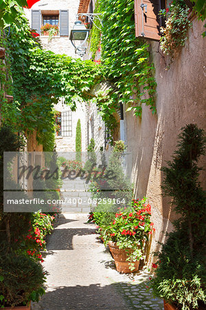 narrow old town street of Provence at sunny summer day, France