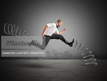 Businessman running fast with the big springs