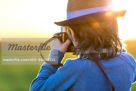 Little boy with a camera outdoors