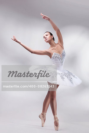 beautiful woman ballet dancer posing in studio