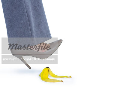 Woman with heel shoes walking on banana on white background