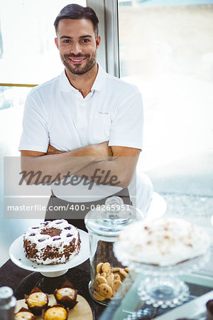 Smiling server arm crossed at the bakery