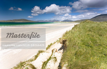 Looking across the machair to the white sand beach of Seilebost at low tide and the hills of Taransay and North Harris, from Seilebost, Isle of Harris, Outer Hebrides, Scotland, United Kingdom, Europe