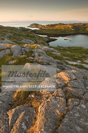 Rocky coasline bathed in early morning light at township of Manish, Isle of Harris, Outer Hebrides, Scotland, United Kingdom, Europe