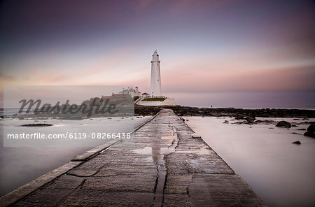 View along the tidal causeway to St. Mary's Island and St. Mary's Lighthouse at dusk, near Whitley Bay, Tyne and Wear, England, United Kingdom, Europe