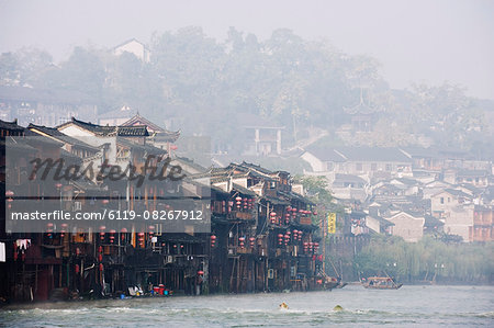 Wooden stilt houses in riverside old town of Fenghuang, Hunan Province, China, Asia