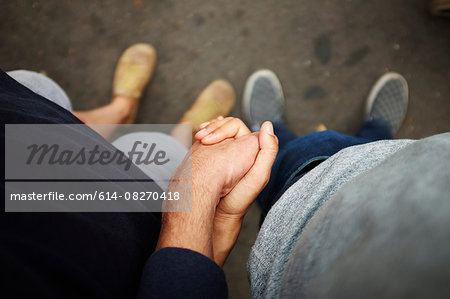 Overhead view of couple holding hands