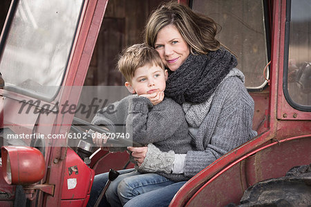 Woman with son sitting in tractor