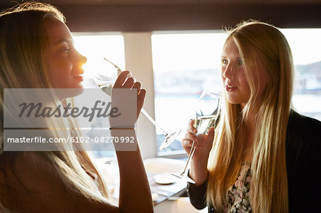 Young women drinking in restaurant