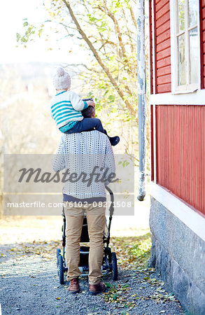 Father carrying child on shoulders