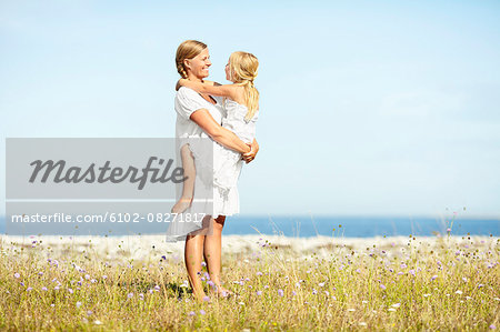 Mother with daughter on meadow