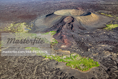 Ethiopia, Erta Ale range, Catherine, Afar Region. Surrounded by vast lava fields, Catherine or Catherina is a round volcanic tuff ring with a crater lake.  The blowhole on its side caused the newest lava flows.