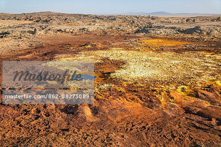 Ethiopia, Dallol, Afar Region. At almost 300 feet below sea level, Dallol is one of the lowest places on earth. Gas vents, geysers, salt, iron stains, sulphur and halophile algae turn the hot springs into a kaleidoscope spectacular colours.