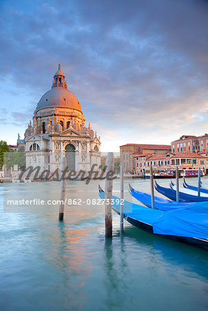 Italy, Veneto, Venice. Gondolas moored on the Gran Canal overlooking Santa Maria della Salute.