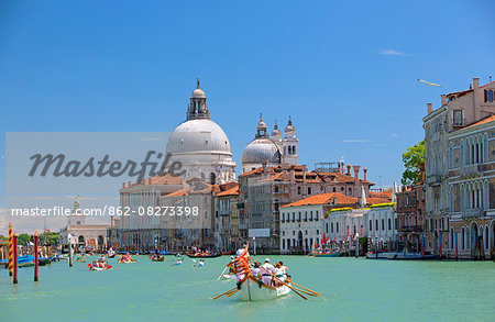 Italy, Veneto, Venice. During the Vongalonga rowing boats in front of the Santa Maria della Salute Church on the Gran Canal.