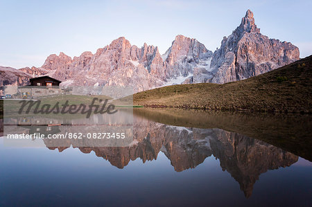 Dolomites Alps, Trentino Alto Adige, Passo Rolle, Italy. Pale di San Martino reflecting on water