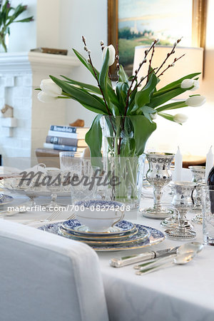 Passover Seder Table Setting in Dining Room with Silverware and Fine China