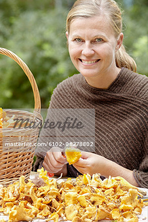 Smiling woman clearing chanterelles