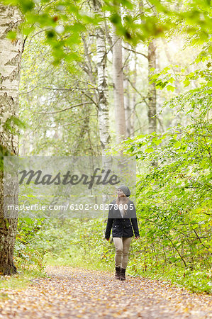 Woman walking in forest