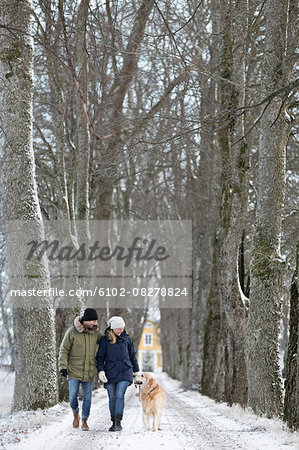 Couple walking with dog