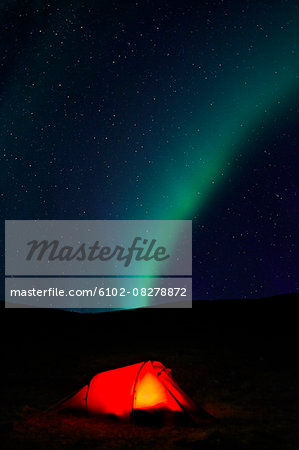 Aurora borealis over tent at night