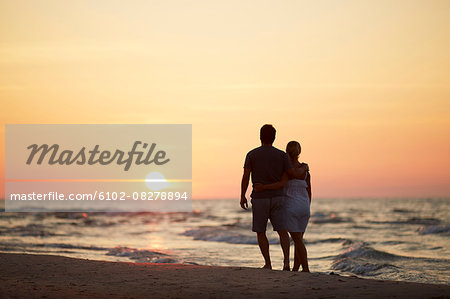 Couple on beach at sunset